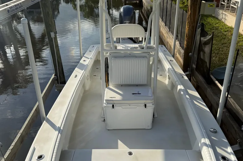 Slide: The Image of 2016 Dorado 23 boat docked on a sunny day, reflecting on calm water. - 4