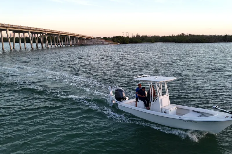 Slide: The Image of 2016 Dorado 23 boat cruising near a bridge at sunset. - 41