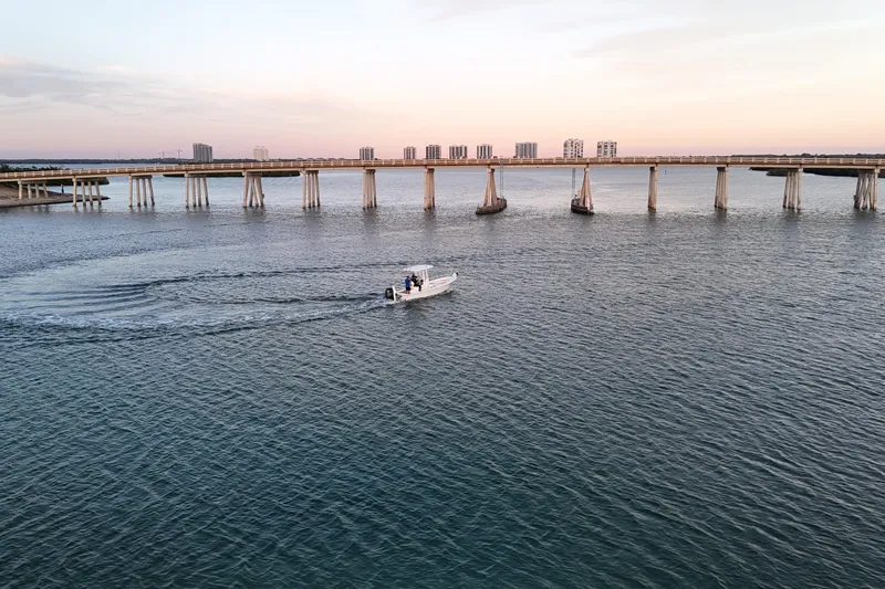 Slide: The Image of Boat cruising under bridge at sunset, Dorado 23, 2016 model. - 46