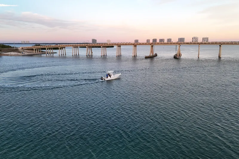 Slide: The Image of Boat cruising under bridge at sunset, Dorado 23, 2016 model. - 47