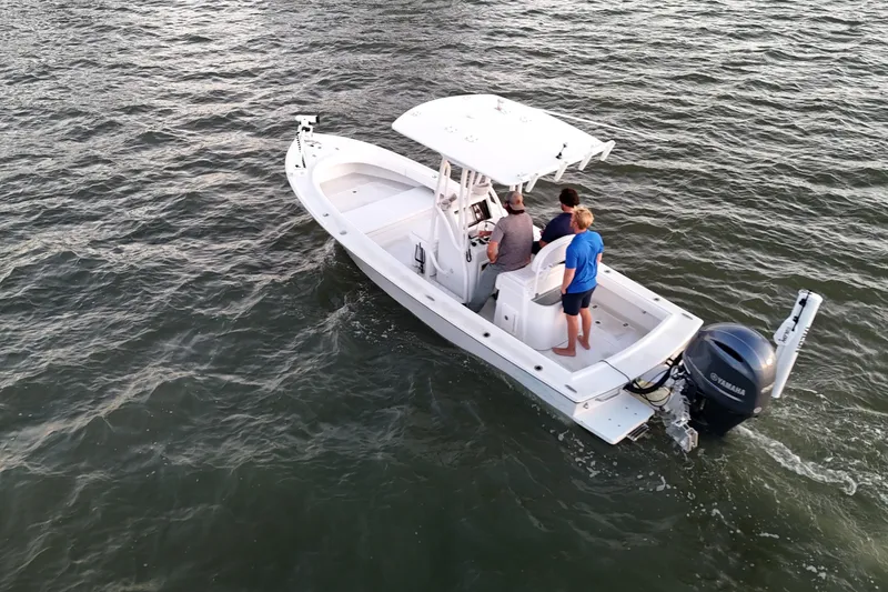 Slide: The Image of 2016 Dorado 23 boat on water with two people onboard. - 52