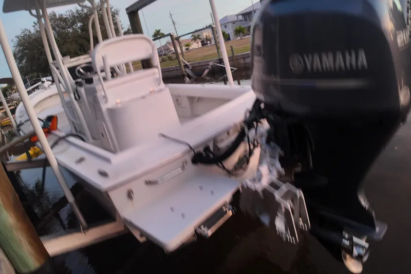 Slide: The Image of 2016 Dorado 23 boat with Yamaha outboard motor docked by the water. - 55