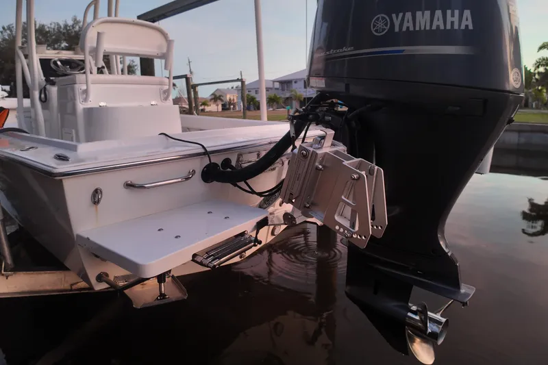 Slide: The Image of Dorado 23 boat (2016) with Yamaha outboard motor, docked by the water. - 56