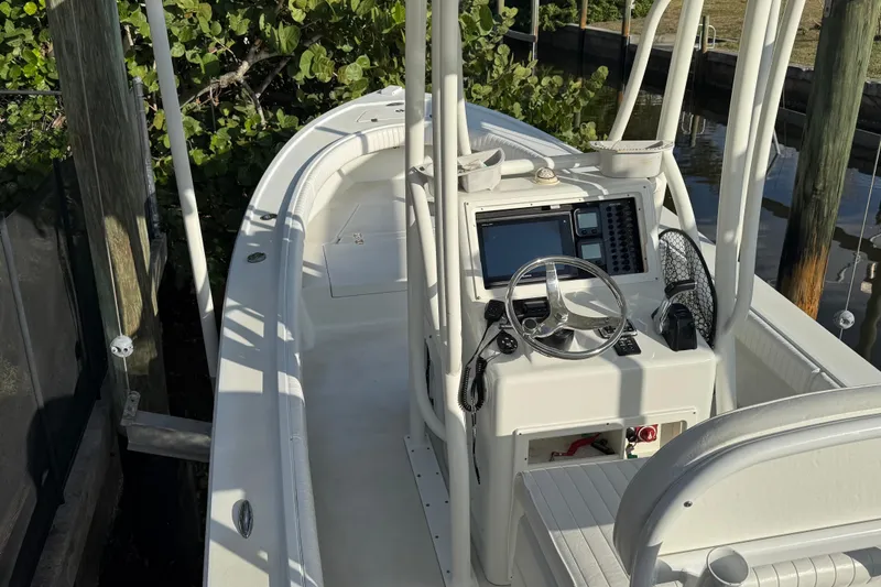 Slide: The Image of 2016 Dorado 23 boat docked in a sunny canal setting. - 6