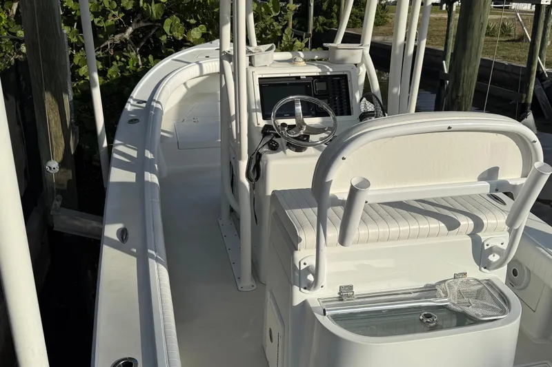 Slide: The Image of 2016 Dorado 23 boat interior with Yeti cooler, docked by the water. - 7