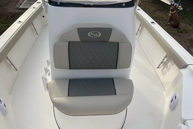 Slide: The Image of 2026 Key West 230 Bay Reef boat interior with cushioned seating and rod holders. - 14