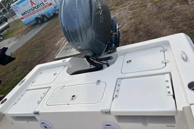 Slide: The Image of 2026 Key West 230 Bay Reef boat with Yamaha outboard motor, parked on grass. - 8