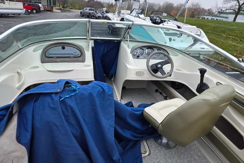 Slide: The Image of 2004 Sea Ray 200 Sport boat interior with steering wheel and dashboard. - 10