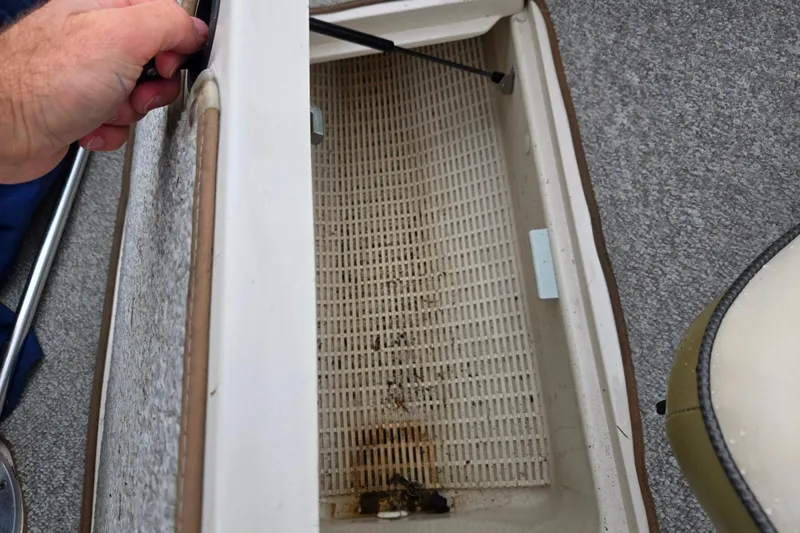 Slide: The Image of Open storage compartment in 2004 Sea Ray 200 Sport boat, showing interior details. - 11