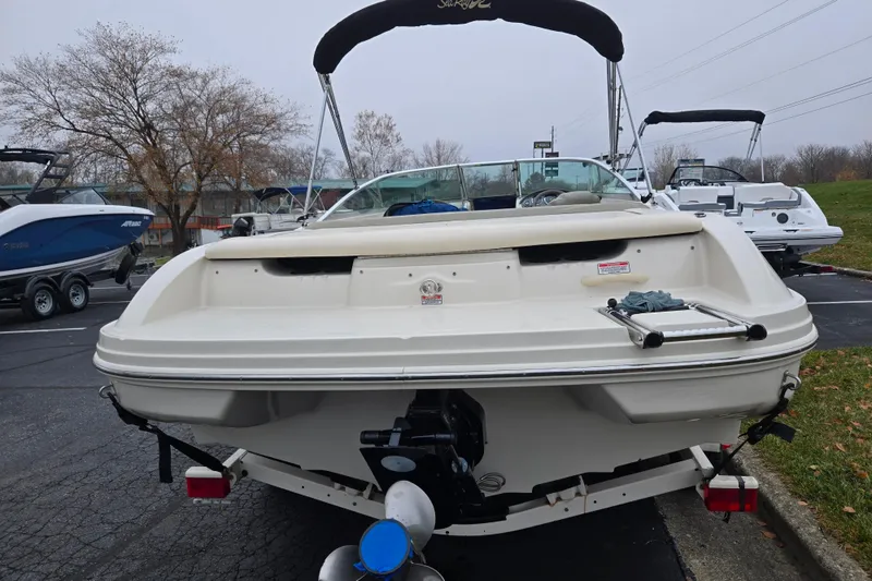 Slide: The Image of 2004 Sea Ray 200 Sport boat, rear view, parked on a trailer in a lot. - 2