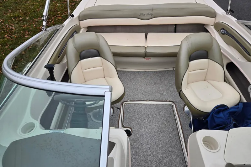 Slide: The Image of 2004 Sea Ray 200 Sport boat interior with beige seating and steering wheel. - 21