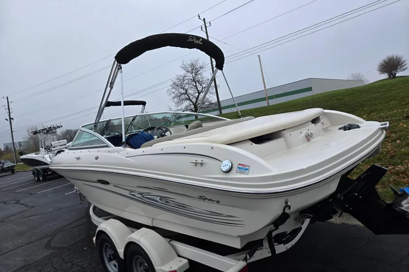 Slide: The Image of 2004 Sea Ray 200 Sport boat on trailer, parked outdoors on a cloudy day. - 3
