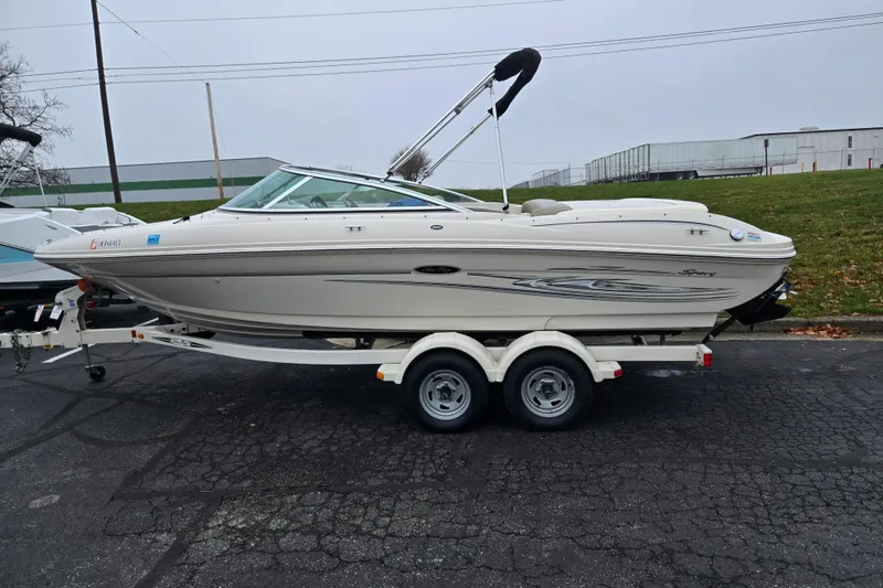 Slide: The Image of 2004 Sea Ray 200 Sport boat on trailer, parked outdoors. - 4