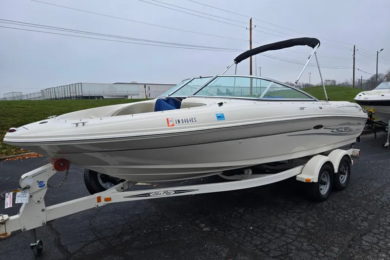 Slide: The Image of 2004 Sea Ray 200 Sport boat on trailer, parked outdoors on overcast day. - 5