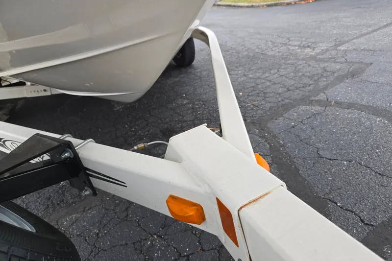 Slide: The Image of 2004 Sea Ray 200 Sport boat on trailer, parked on asphalt surface. - 7