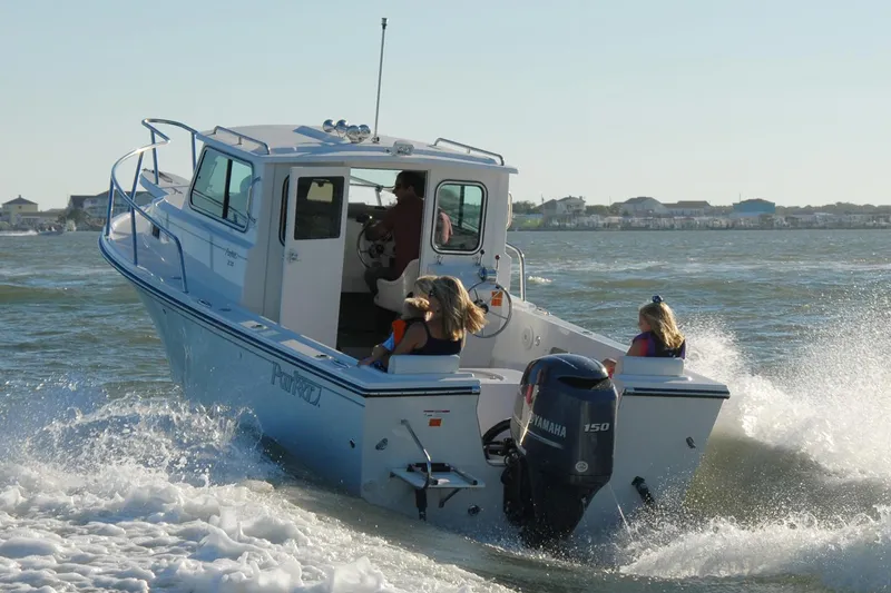 Slide: The Image of Manufacturer Provided Image: 2016 Parker 2120 Sport Cabin boat cruising on water with passengers. - 3