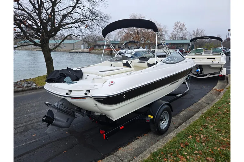 Slide: The Image of 2016 Stingray 198 RX boat on trailer near waterfront, overcast day. - 1