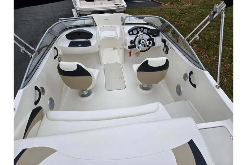 Slide: The Image of 2016 Stingray 198 RX boat interior with dual seats and steering console. - 10