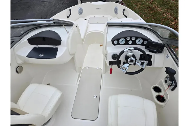 Slide: The Image of 2016 Stingray 198 RX boat interior with steering wheel and dashboard controls. - 12