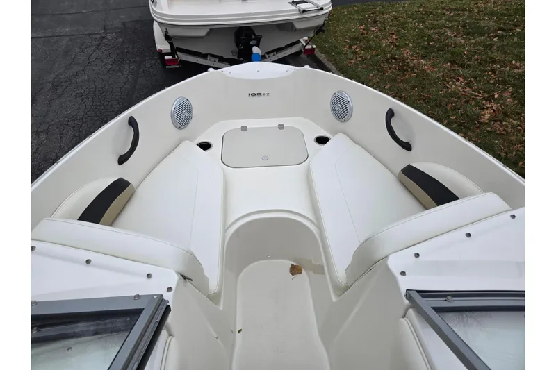Slide: The Image of 2016 Stingray 198 RX boat interior with white seating and speakers. - 18
