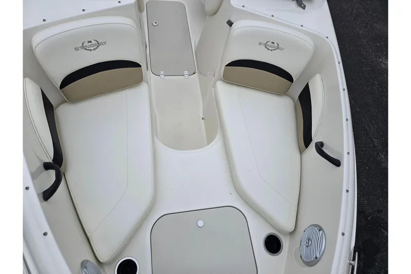 Slide: The Image of 2016 Stingray 198 RX boat interior with beige and black seating. - 20