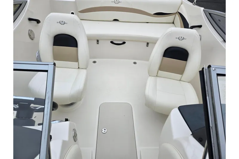 Slide: The Image of 2016 Stingray 198 RX boat interior with white seating and steering area. - 22