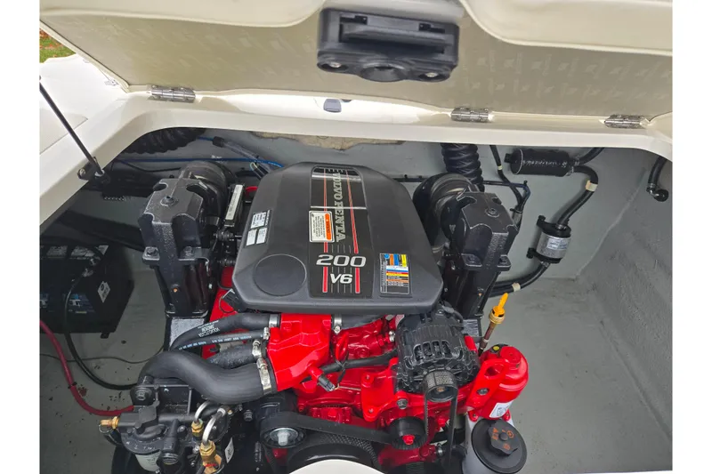 Slide: The Image of Engine compartment of a 2016 Stingray 198 RX boat, featuring a 200 V6 engine. - 24