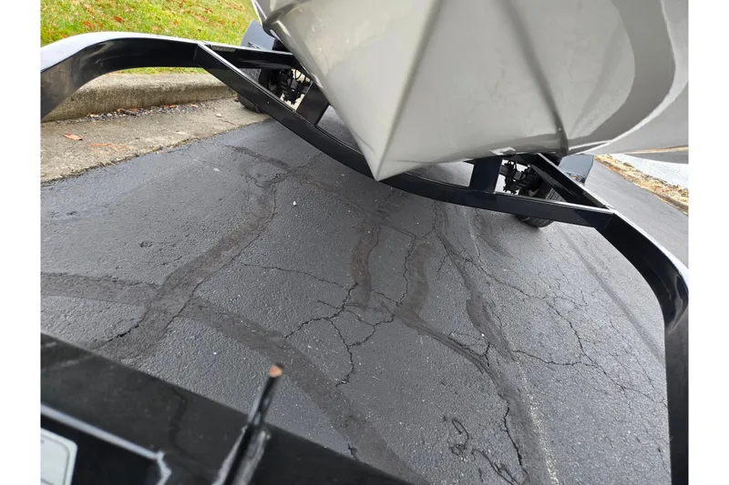 Slide: The Image of 2016 Stingray 198 RX boat on trailer, parked on cracked asphalt pavement. - 7