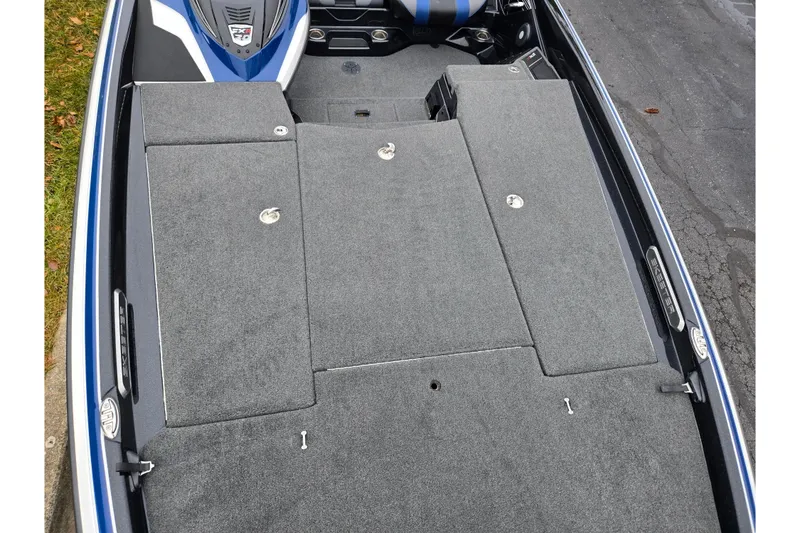 Slide: The Image of 2021 Skeeter FXR20 boat deck with gray carpet and storage compartments. - 10