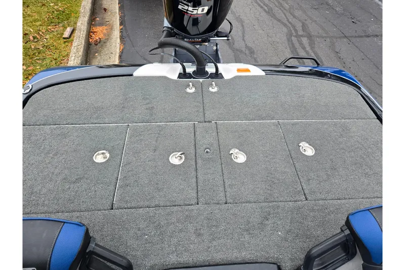 Slide: The Image of 2021 Skeeter FXR20 boat deck with Yamaha 250 engine, featuring carpeted storage compartments. - 13