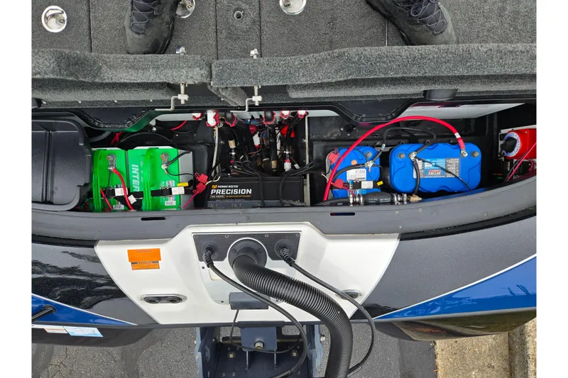 Slide: The Image of 2021 Skeeter FXR20 boat battery compartment with multiple batteries and wiring. - 15