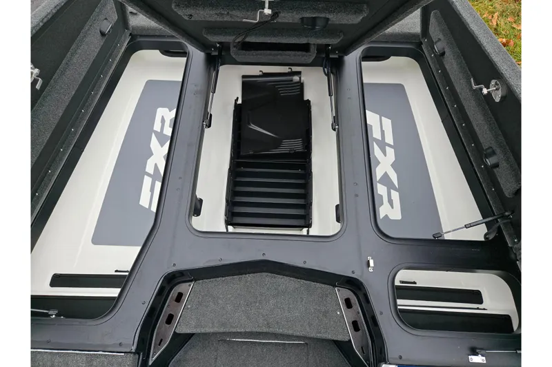 Slide: The Image of 2021 Skeeter FXR20 boat storage compartments with open lids, showcasing interior design. - 24