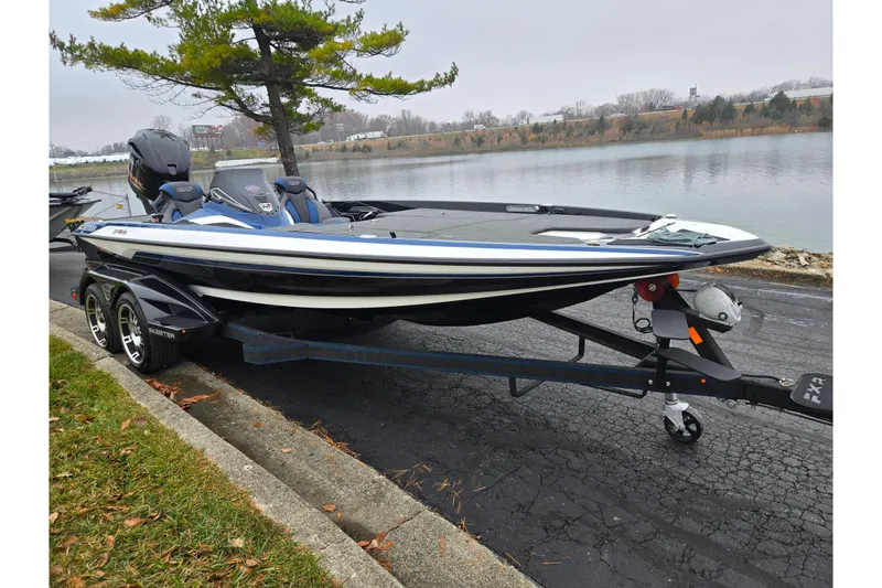 Slide: The Image of 2021 Skeeter FXR20 boat on trailer by a lakeside, overcast day. - 8