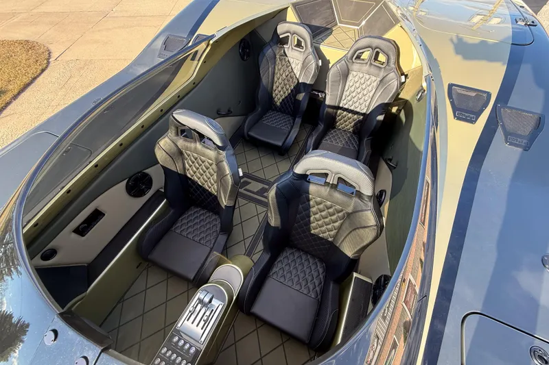Slide: The Image of Interior of 2002 MTI 40RP boat with four luxury seats and sleek design. - 13