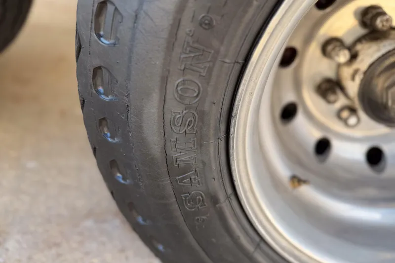 Slide: The Image of Close-up of a worn Samson tire on an MTI 40RP, 2002 model. - 26