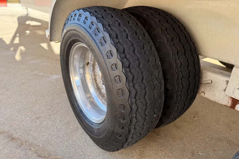 Slide: The Image of Dual tires on a 2002 MTI 40RP trailer, parked on concrete. - 28