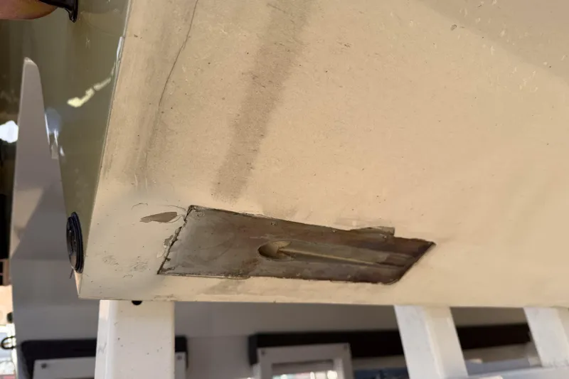 Slide: The Image of Close-up of 2002 MTI 40RP boat hull with visible wear and metal fitting. - 36