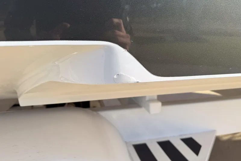 Slide: The Image of Close-up of a 2002 MTI 40RP boat with minor hull damage. - 38