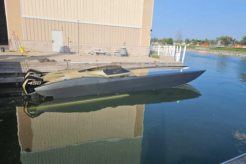 Slide: The Image of High-performance 2002 MTI 40RP speedboat docked, featuring twin 450R engines. - 41