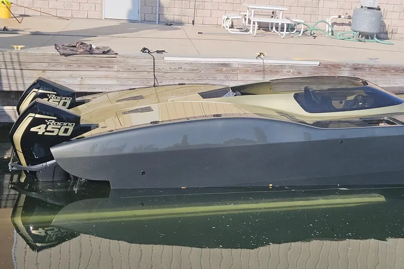 Slide: The Image of 2002 MTI 40RP boat with dual Racing 450 engines docked at a marina. - 44