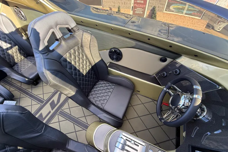 Slide: The Image of Luxurious MTI 40RP 2002 boat interior with diamond-stitched seats and sleek steering wheel. - 9