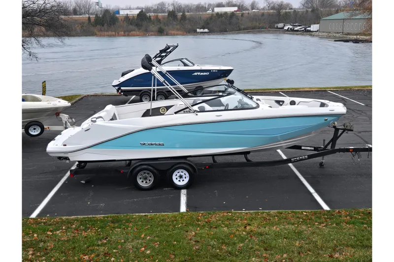 The Image of 2021 Scarab 255 ID boat on trailer by a lakeside parking lot. - 0