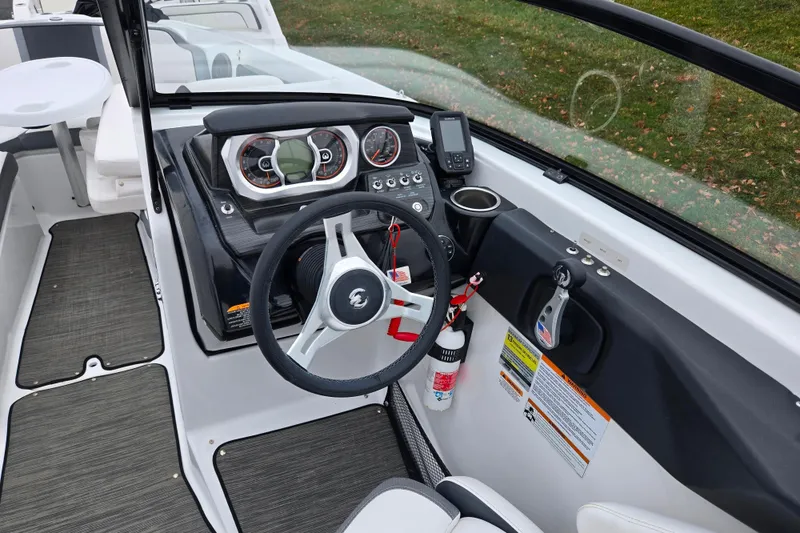 Slide: The Image of 2021 Scarab 255 ID boat cockpit with steering wheel and control panel. - 12