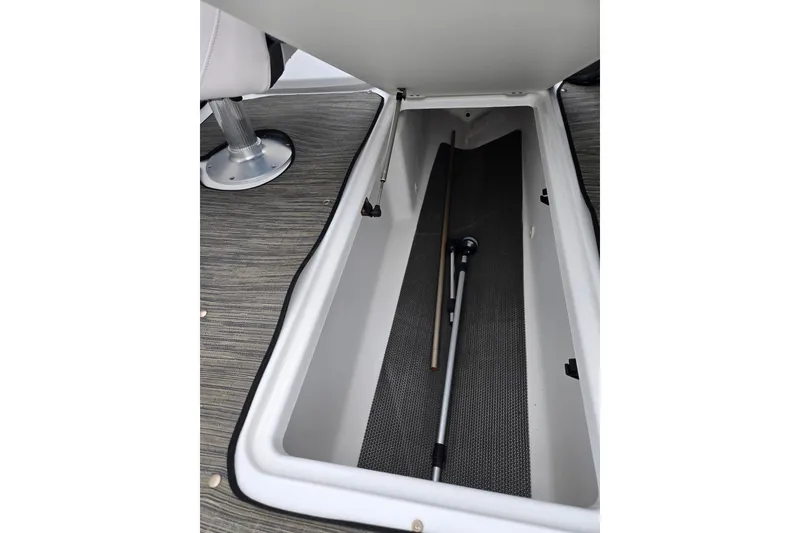 Slide: The Image of 2021 Scarab 255 ID boat storage compartment with equipment inside. - 18
