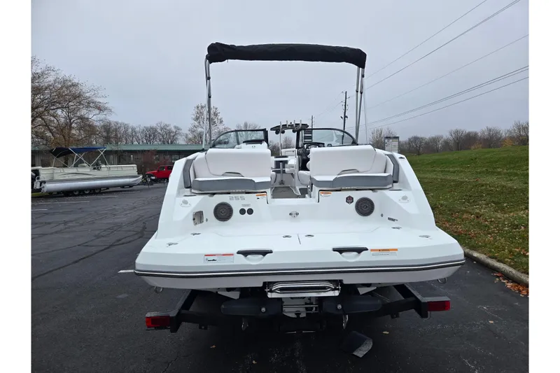 Slide: The Image of Rear view of a 2021 Scarab 255 ID boat parked outdoors on a cloudy day. - 2