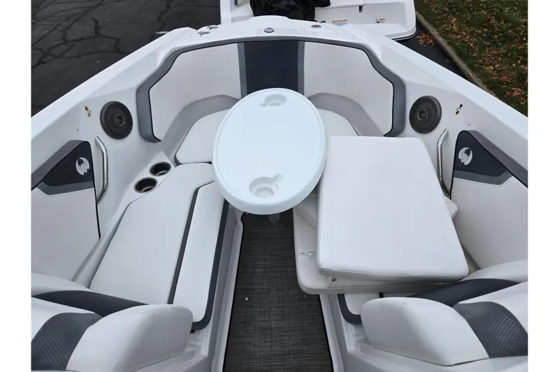 Slide: The Image of 2021 Scarab 255 ID boat interior with seating, table, and cup holders. - 20