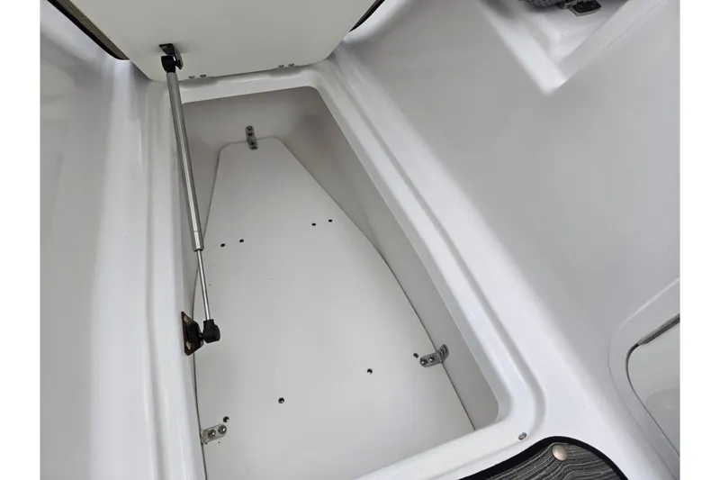 Slide: The Image of Open storage compartment in 2021 Scarab 255 ID boat, featuring hydraulic lift support. - 21