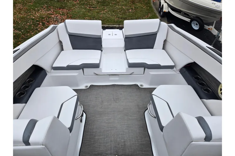 Slide: The Image of 2021 Scarab 255 ID boat interior with white and gray seating, cup holders, and spacious layout. - 26