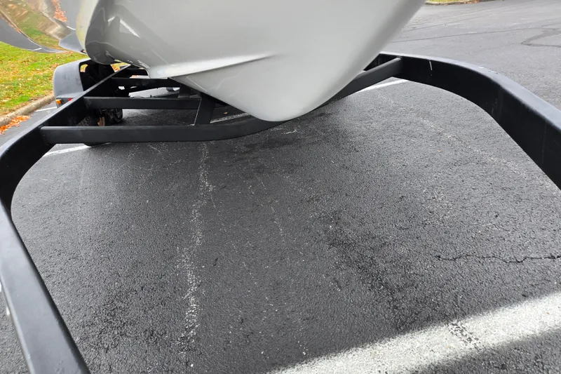 Slide: The Image of 2021 Scarab 255 ID boat on trailer, parked on asphalt surface. - 7