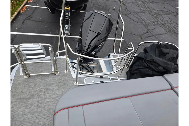 Slide: The Image of 2022 Bennington LX 24 Swingback boat with outboard motor and seating area. - 17